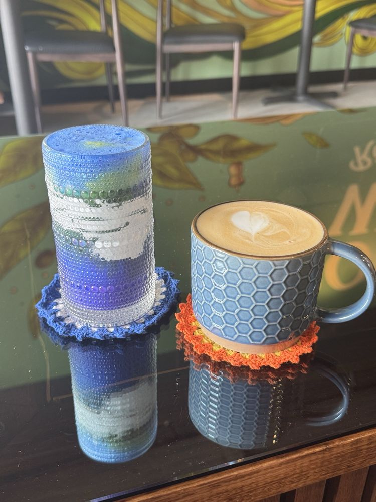 A bright blue Coffee Wave Blue Ocean Matcha in a textured glass