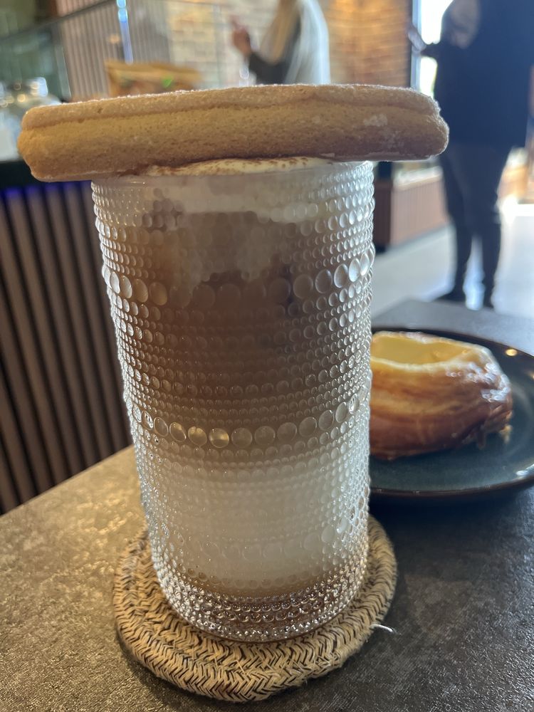 Coffee Wave's iced Tiramisu Latte topped with a ladyfinger